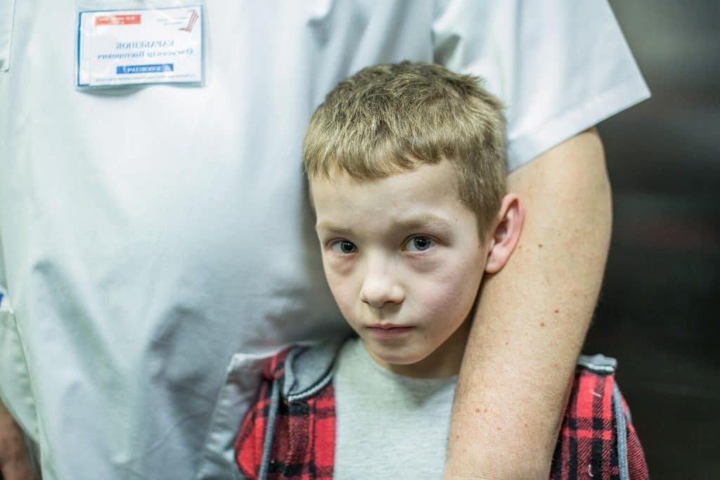 Le 3 mars 2022, Mikhailo, 10 ans, est photographié dans les bras de son père, médecin à l'hôpital pour enfants Okhmatdyt de Kiev, en Ukraine. ©UNICEF/UN0601017/Ratushniak