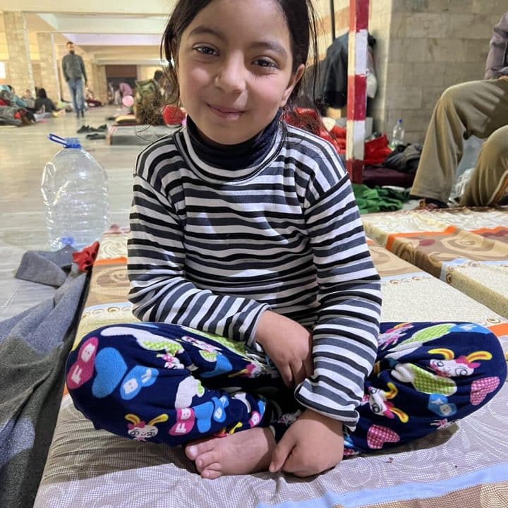 Le 13 février 2023 à Lattaquié, en Syrie, Aya, 6 ans, est assise sur un matelas dans le centre sportif de Lattaquié, où sa famille et des centaines d'autres personnes ont trouvé refuge après avoir été déplacées à la suite du tremblement de terre qui a frappé la Syrie le 6 février. © UNICEF/UN0782750/
