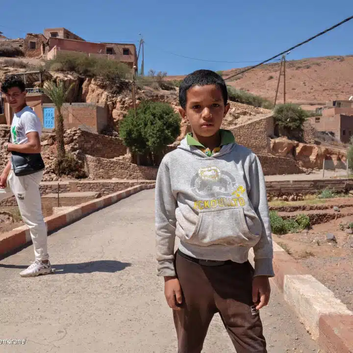 Le 10 septembre 2023, Marwan, 9 ans, se tient devant son village, Azro, près de Tahanaout dans les montagnes de l'Atlas au Maroc, qui a été détruit par un important tremblement de terre. © UNICEF/UNI434147/Benkirane