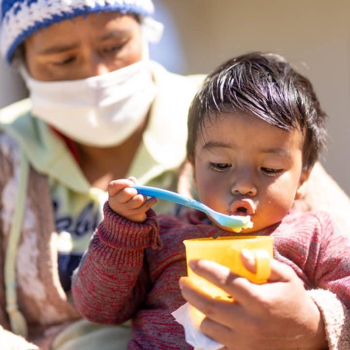 Le 2 septembre 2020 au Guatemala, Erick Samuel, 18 mois, mange une purée de pêche avec des vitamines fournies par les équipes de l'UNICEF. ©UNICEF/UN0373501/Billy/AFP-Services
