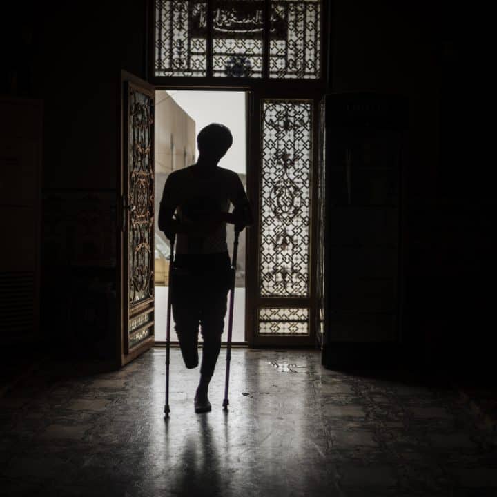 On 2 March 2022 in Iraq, a portrait of 18-year-old Muqtada made inside his home in Basra. When he was 16, he was injured by a landmine explosion close to the border with Iran and lost his right foot and part of his right leg. “People go to this field to take grass or steel,” Muqtada says. “People remove the fence and we don’t know where are the limits of these contaminated areas.” After the explosion, Muqtada dragged himself towards an approaching car to seek help. The driver stopped, but did not get out of the car for fear of landmines in the area. Once Muqtada had hoisted himself into the car, he passed out. He doesn't remember anything about the explosion – only waking up in the hospital without a leg. He says, “Before, I used to play soccer every day and go out with my friends. Now I can't do that.”