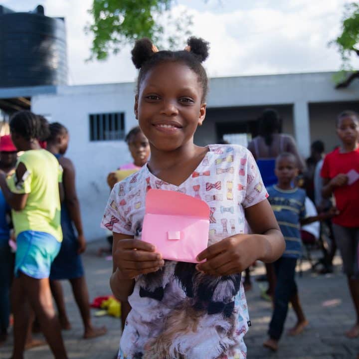 A girl shows her work created during a psychosocial and educational workshop organized by APADEH in collaboration with UNICEF at the École Nationale Argentine de Belgarde in Port-au-Prince, Haiti, April 12, 2024. © UNICEF/UNI557549/Erol