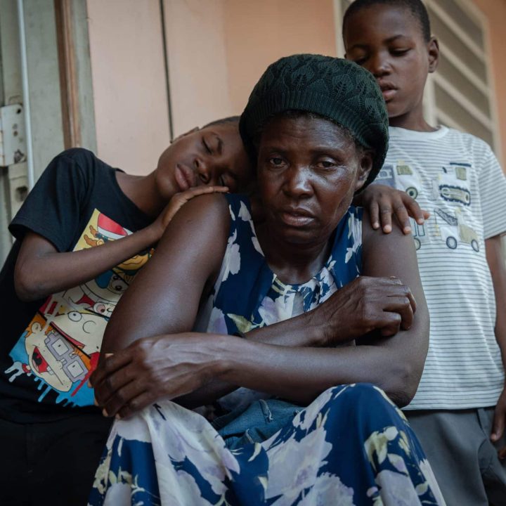 Evens et Iveneson, 9 ans, avec leur mère Guetty, sur le balcon du centre pour déplacés où ils résident actuellement, le 26 mai 2024. ©UNICEF/UNI582661/Le Lijour