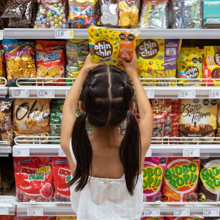 On 30 March 2023 in Lima, Peru, Micaella Delgado, 8, takes a package of candy from the shelf in a supermarket. She chooses the candies that are displayed at her height. © UNICEF/UN0846048/Goupil - Highway Child