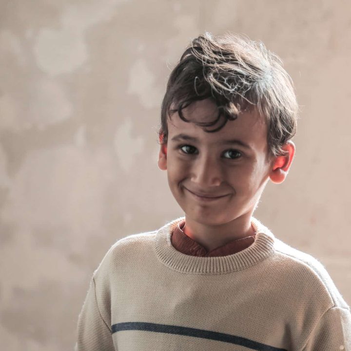 Mohammed essaye les vêtements chauds qu'il a reçu dans le kit hiver distribué par les équipes de l'UNICEF. © UNICEF/UNI901325/Nateel